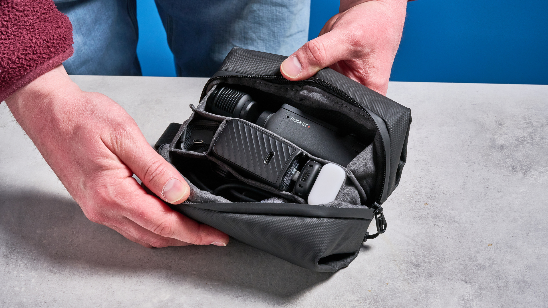 DJI Osmo Pocket 4 against a blue background