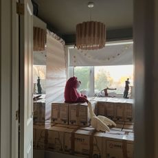 Bedroom with cuddly toys on top of stacked packing boxes