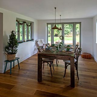 white dining room with table and wooden floor