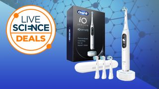 An Oral-B iO Series 10 electric toothbrush, with several spare heads and its box next to it, 