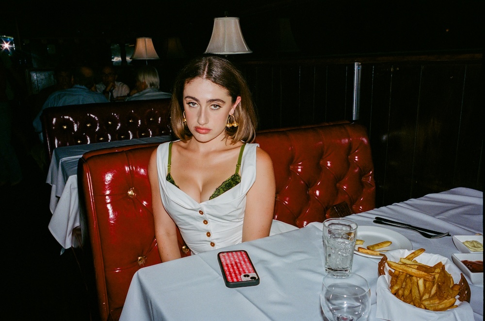 Rachel Sennot on the set of I Love LA in a white costume