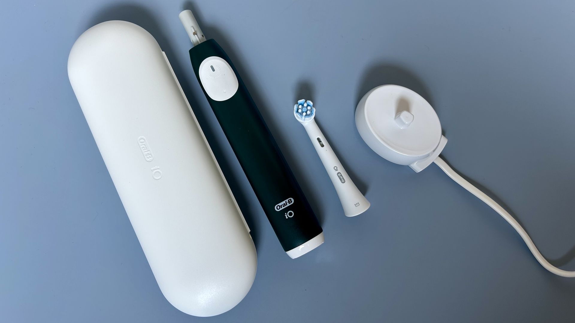 The ‍Oral-B iO2 electric ‌toothbrush⁣ in its charging base.