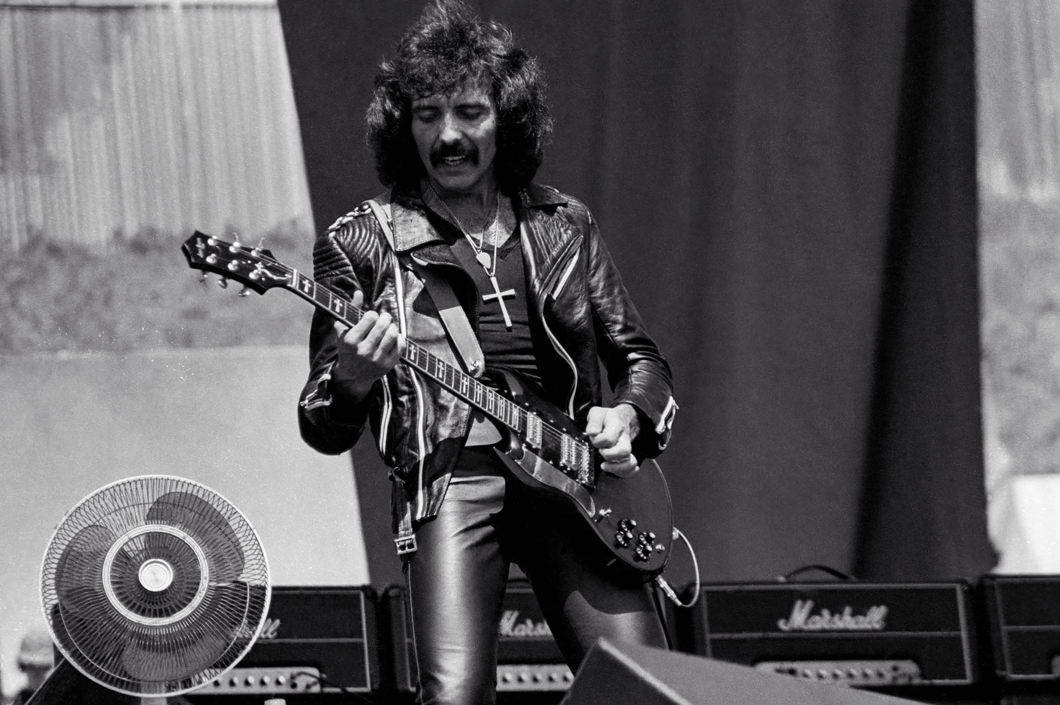 Tony Iommi plays live with Black Sabbath in 1980 with a bank of Marshalls behind him.