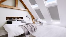 Window blinds in a loft conversion bedroom by Direct Blinds