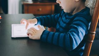 Best drawing tablet for kids: Little boy using iPad