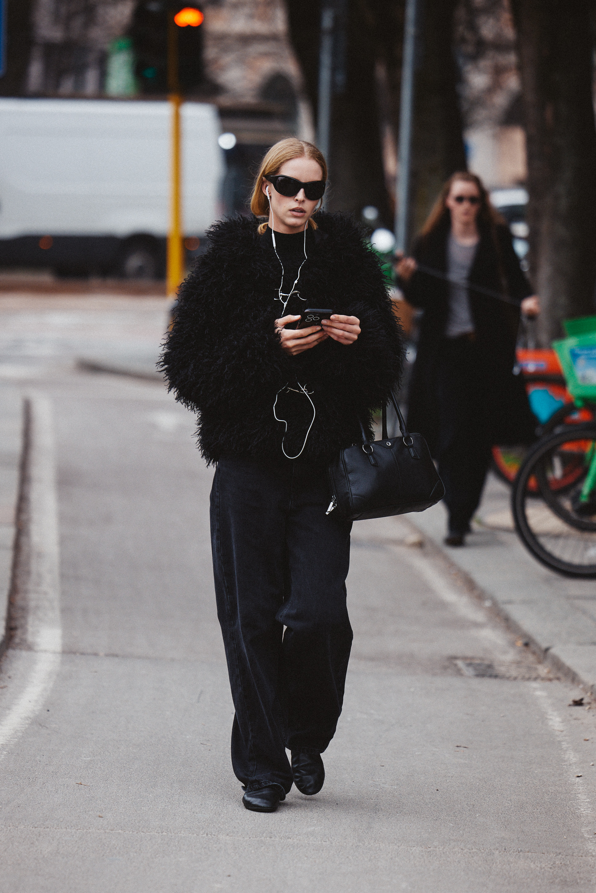 An image of Abby Champion at Milan Fashion Week wearing ultra-baggy, low-rise black jeans.