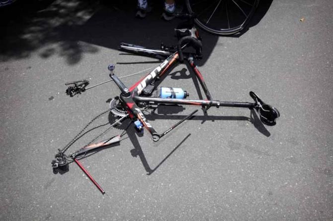 A rider's bike in pieces after a high-speed crash