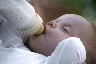 A baby being fed with a bottle