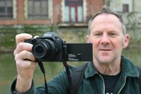 Man holding Nikon Z50 II 