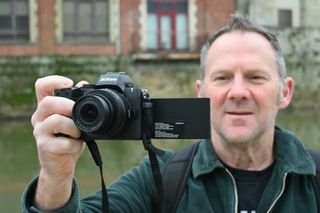 Man holding Nikon Z50 II 