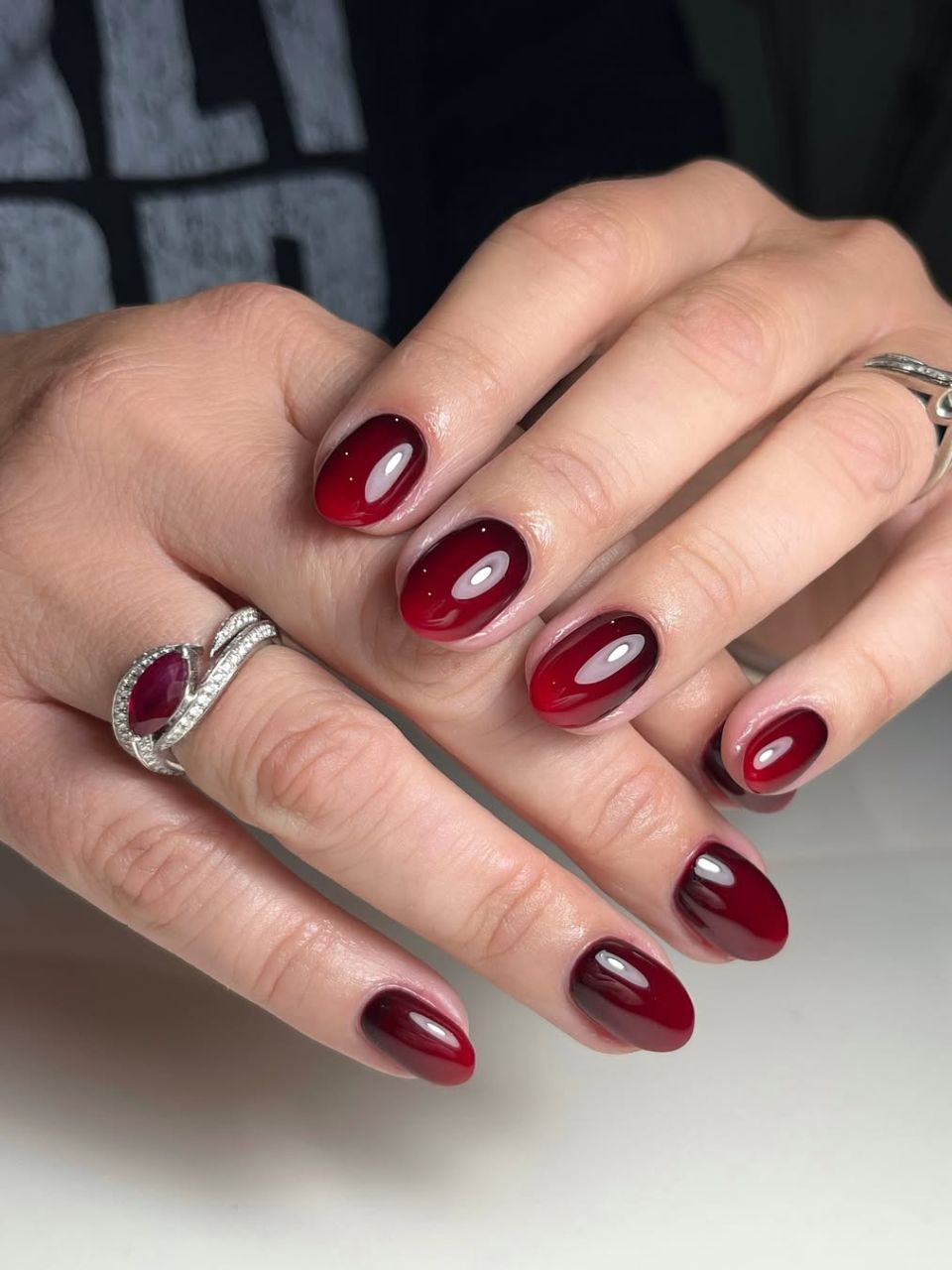 An image featuring an ombre burgundy design by @meraki_nails_cardiff