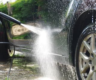 Cleaning a car with a pressure washer