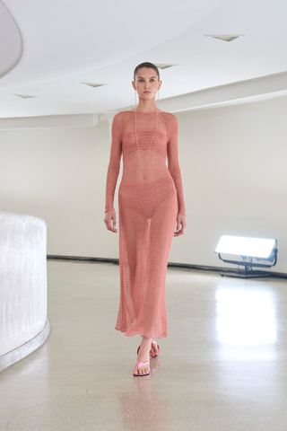 Model wears dusty rose on the Alaia runway.