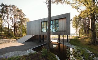 Villa Grieg rises and rotates, with the main body of the house floating above the ground plane, like a sculpted treehouse
