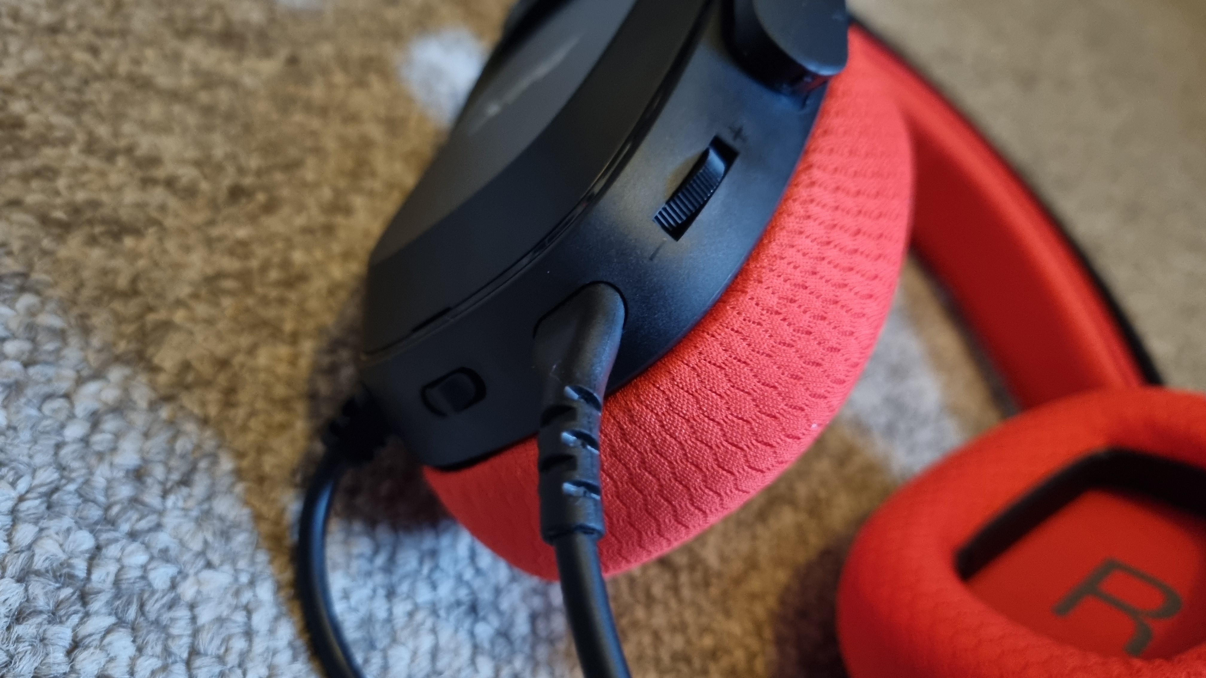 The left earcup of the XPG Precog Studio gaming headset, showing the controls.