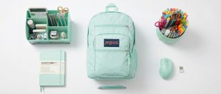 A selection of mint green home office gear on a white desk