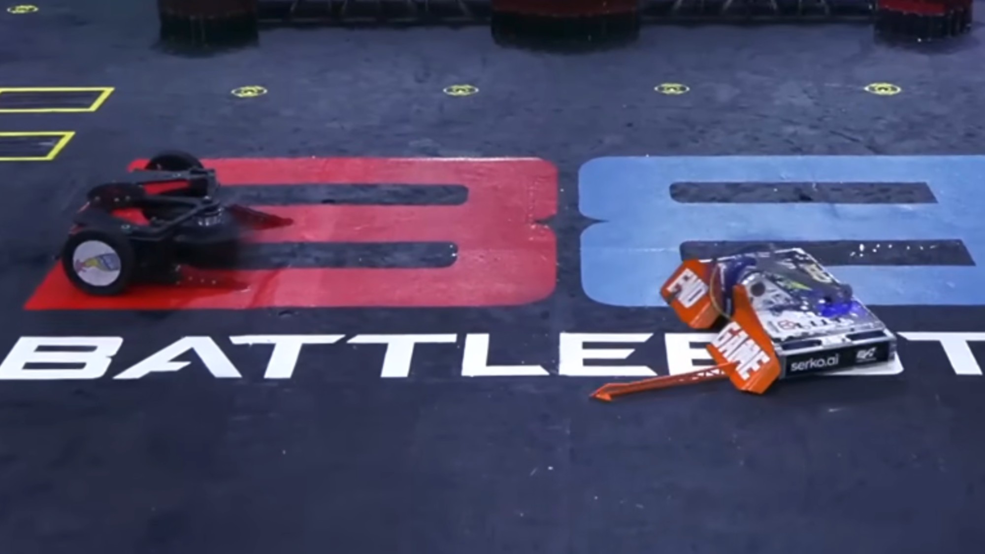 Two robots facing off in the BattleBots Pro League arena.