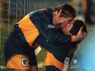 Diego Maradona and Claudio Caniggia share a kiss after a goal for Boca Juniors against River Plate in 1996.