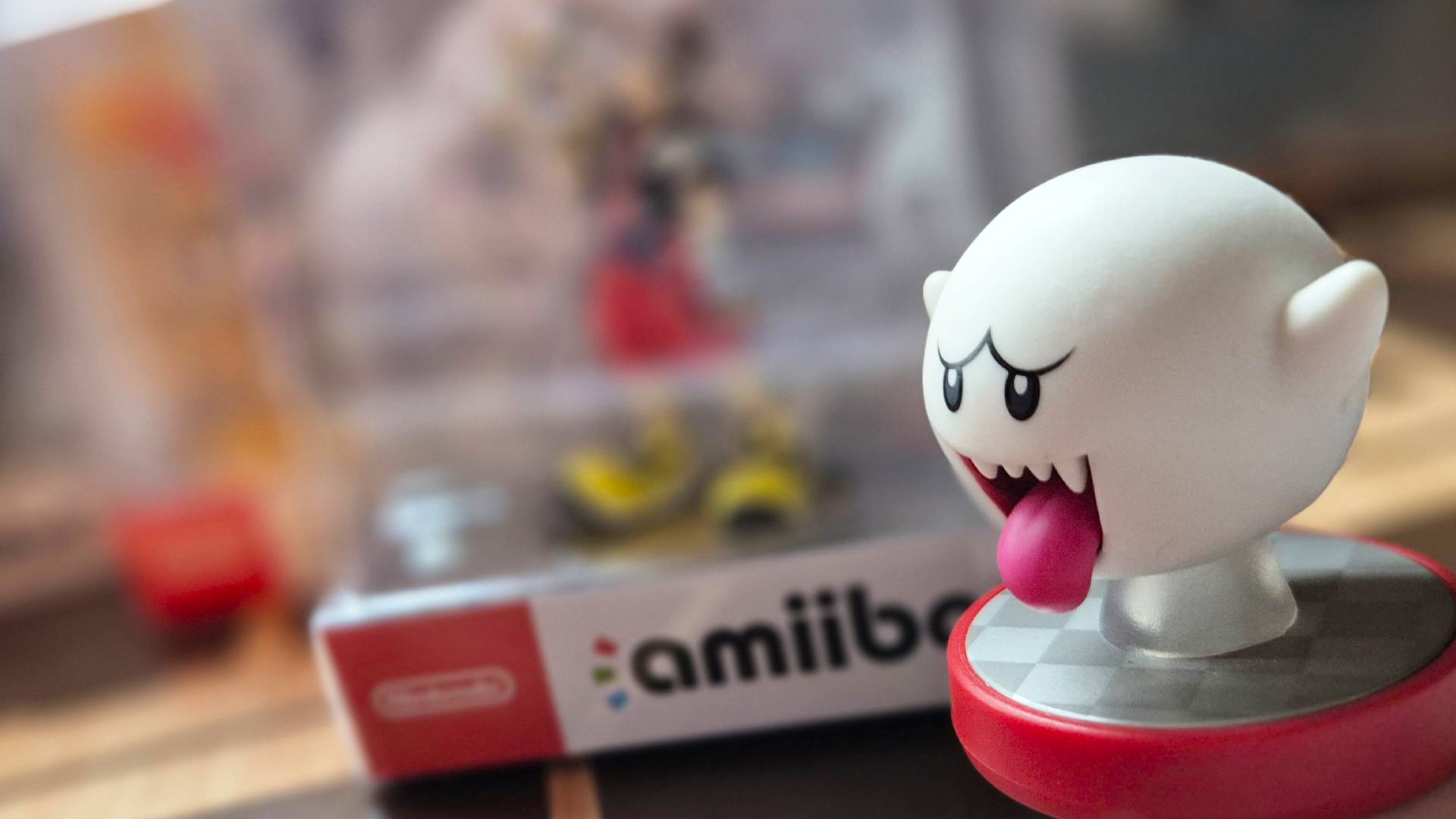 Photo of the Super Mario Boo amiibo in the foreground, with the boxed Sora Kingdom Hearts amiibo blurred in the background.