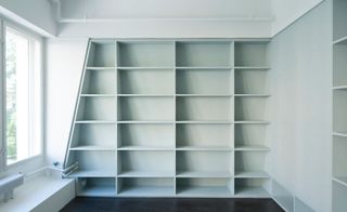 The bespoke shelving wall with blank canvas