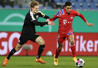 13 January 2021, Schleswig-Holstein, Kiel: Football: DFB Cup, Holstein Kiel - Bayern Munich, 2nd round at Holstein Stadium. Kiel&#039;s Johannes van den Bergh (l) and Munich&#039;s Jamal Musiala in action.