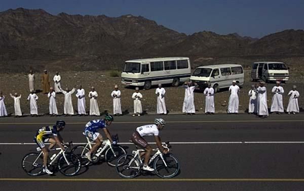 Spectators cheer on passing racers.