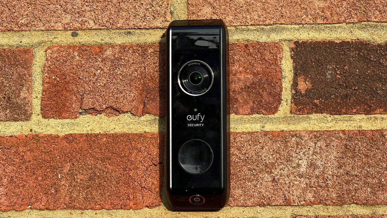 The front view of the Eufy Video Doorbell Dualon a brick wall