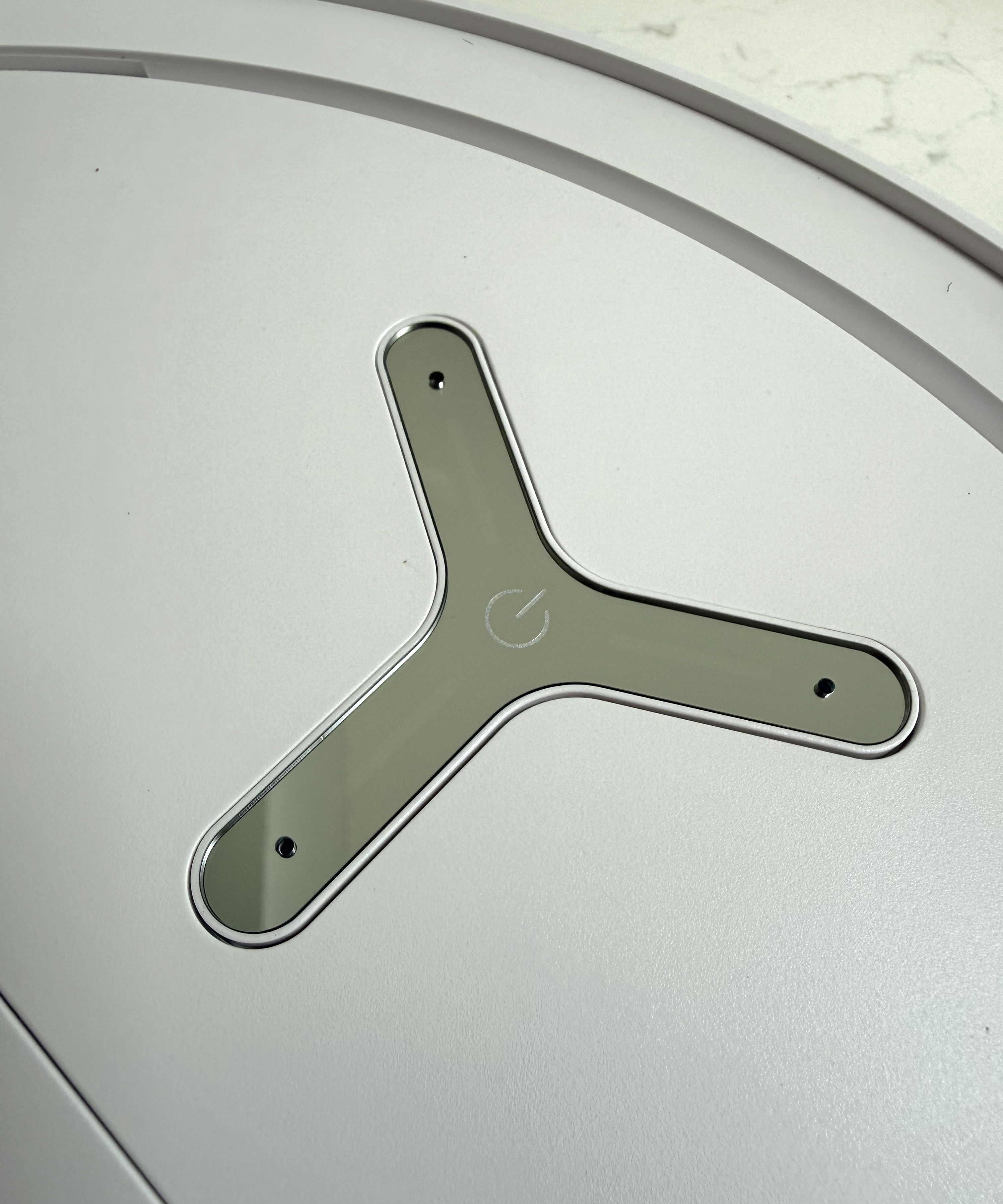 Close-up of the top control button on the Ecovacs Deebot T50 Pro Omni robot vacuum