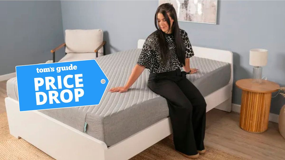 A woman sits on the Siena Memory Foam Mattress with a deals label