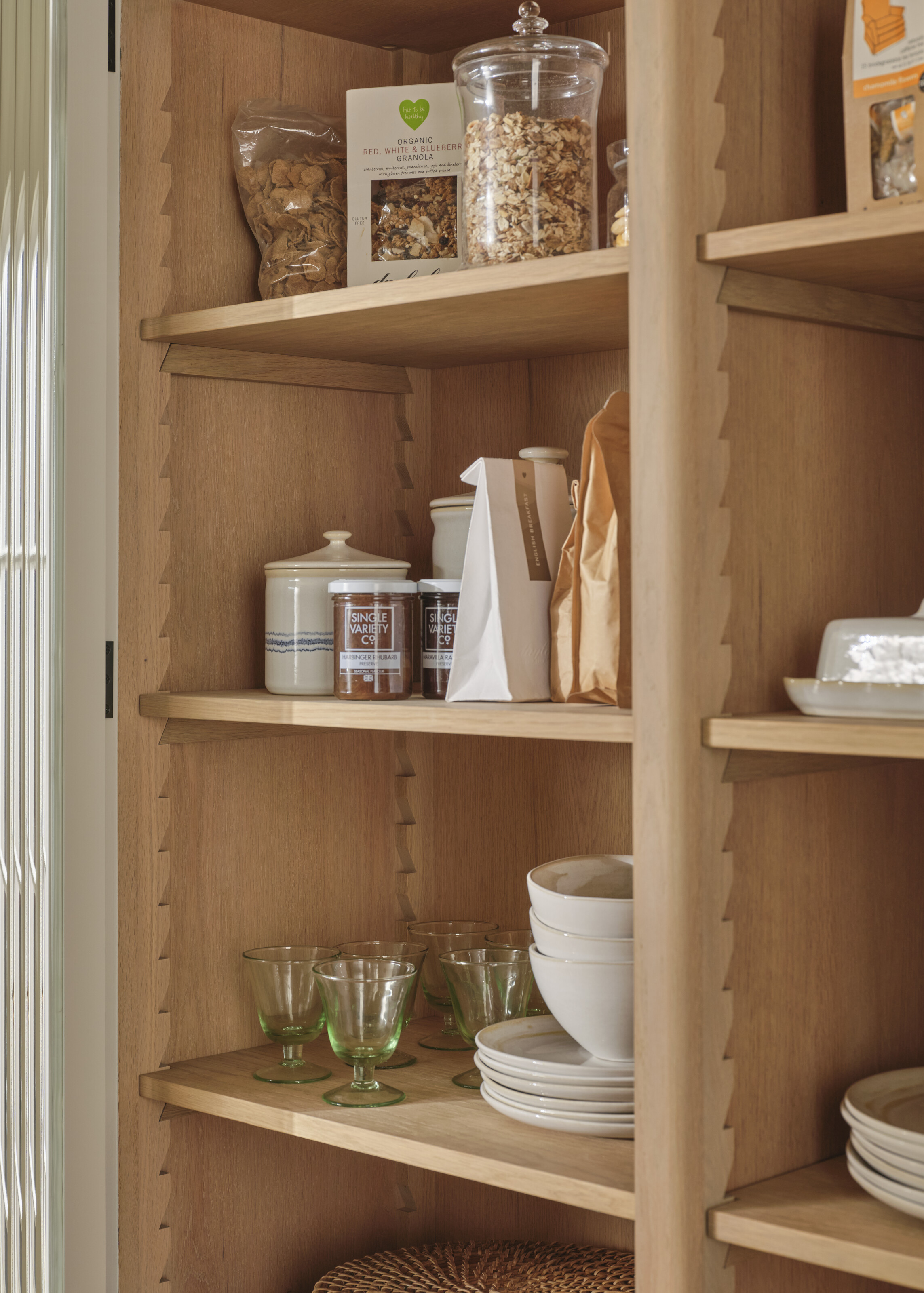 inside of a kitchen cabinet with zig-zag shelving