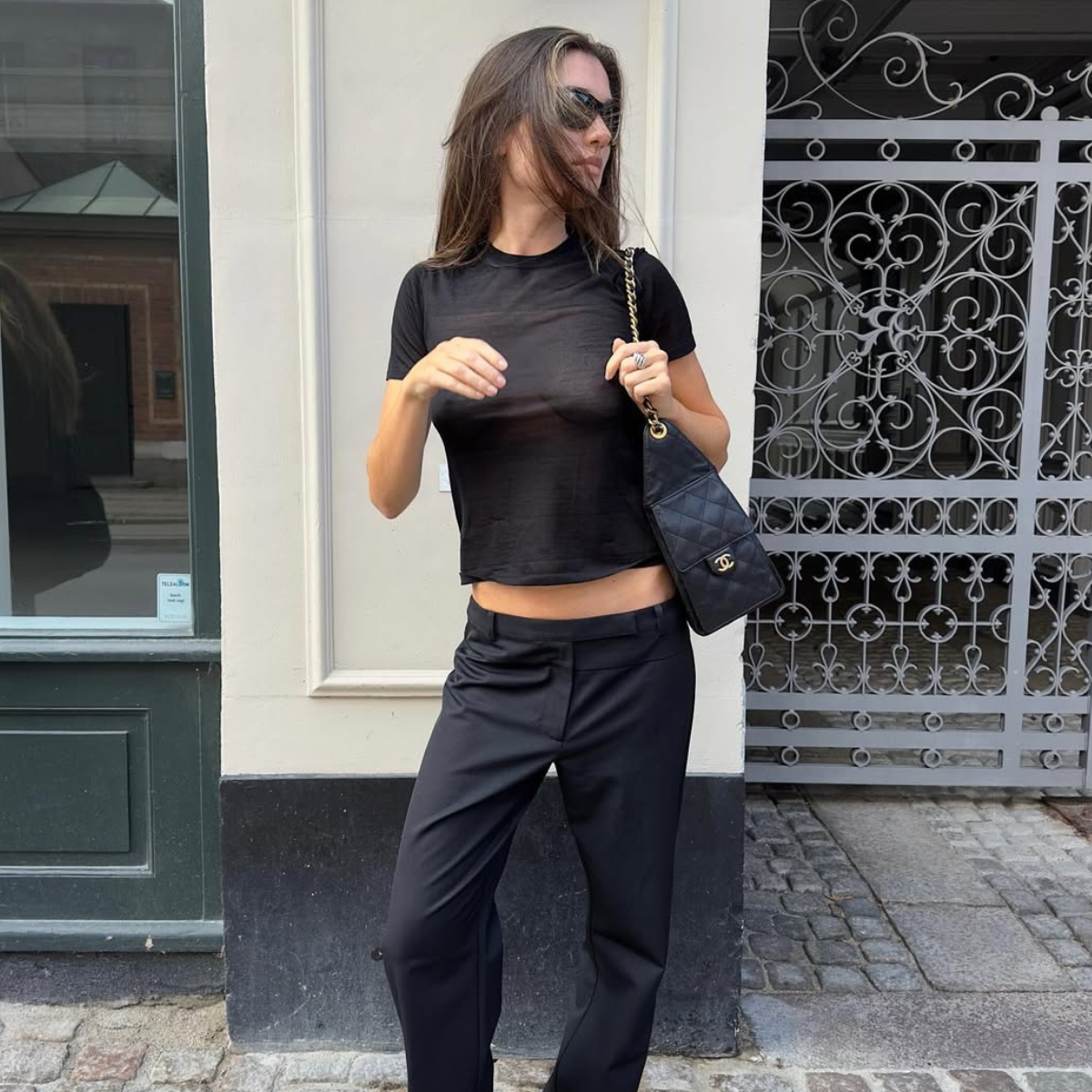 Ilirida in black baby tee and low-rise trousers