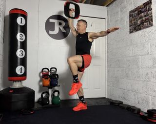 Les Mills trainer Justin Riley demonstrating a lateral lunge to single-leg knee drive to curl to press