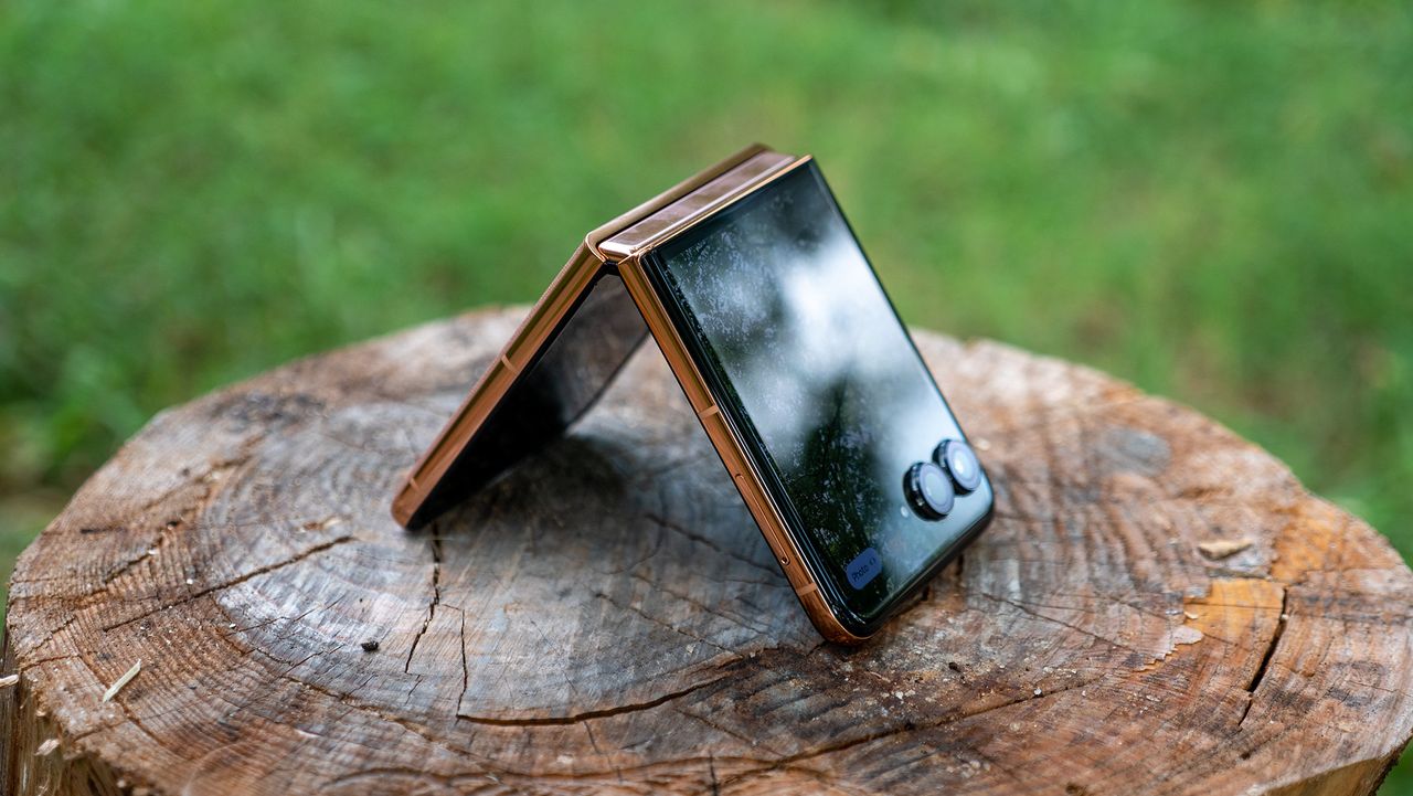 The Mocha Mousse Motorola Razr Plus 2025 tented on a stump