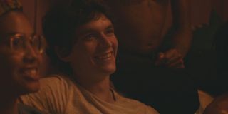 Leyna Bloom and Fionn Whitehead smiling as Wye and Paul at a party in Port Authority