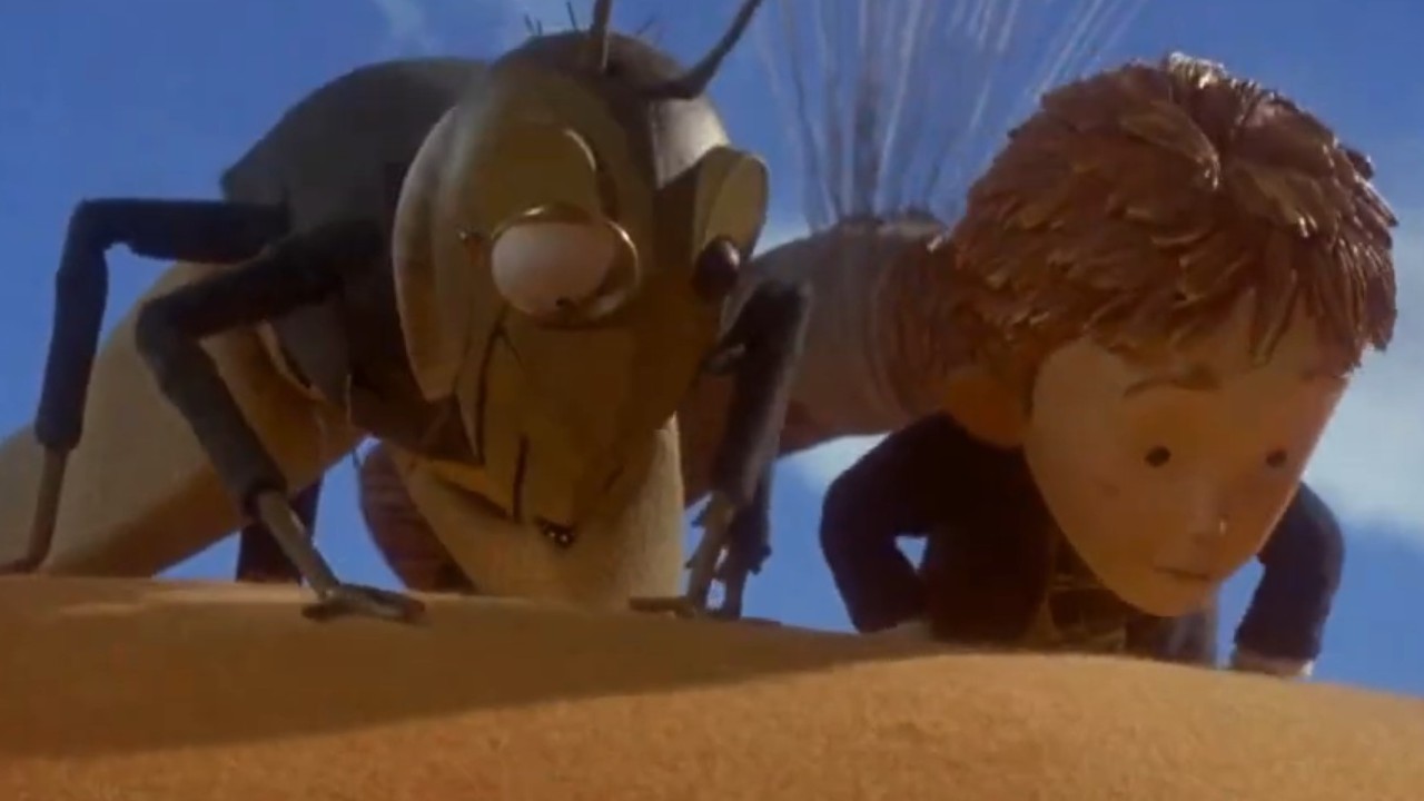 James looking down from a peach with his friend Mr. Grasshopper in James and the Giant Peach