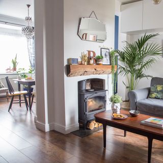 Open-plan living room and dining space divided by chimney breast partition