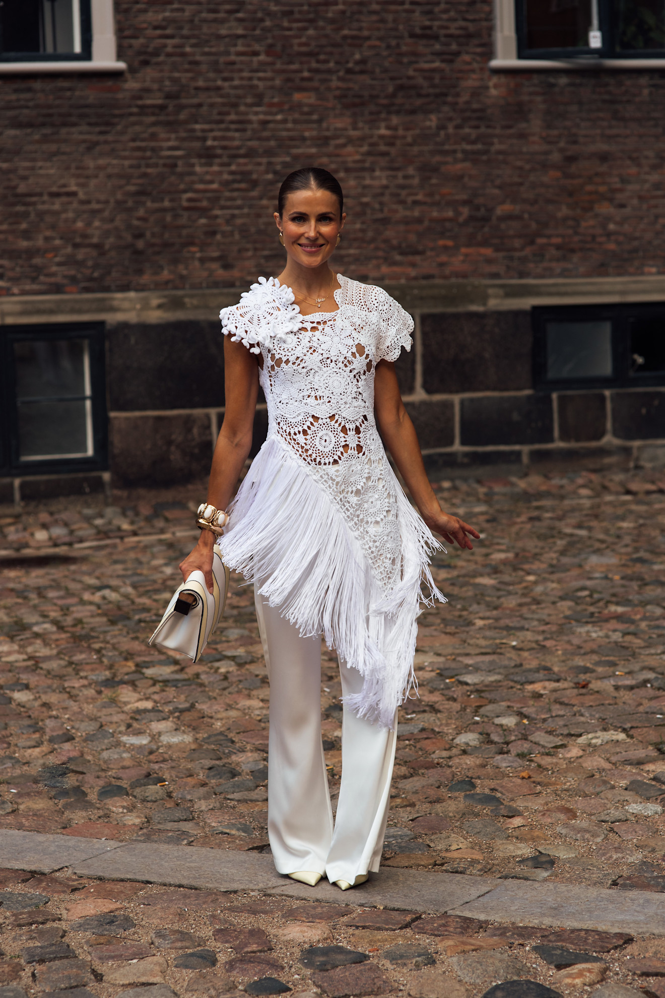 Woman wearing a white dress during Copenhagen Fashion Week spring/summer 2027.