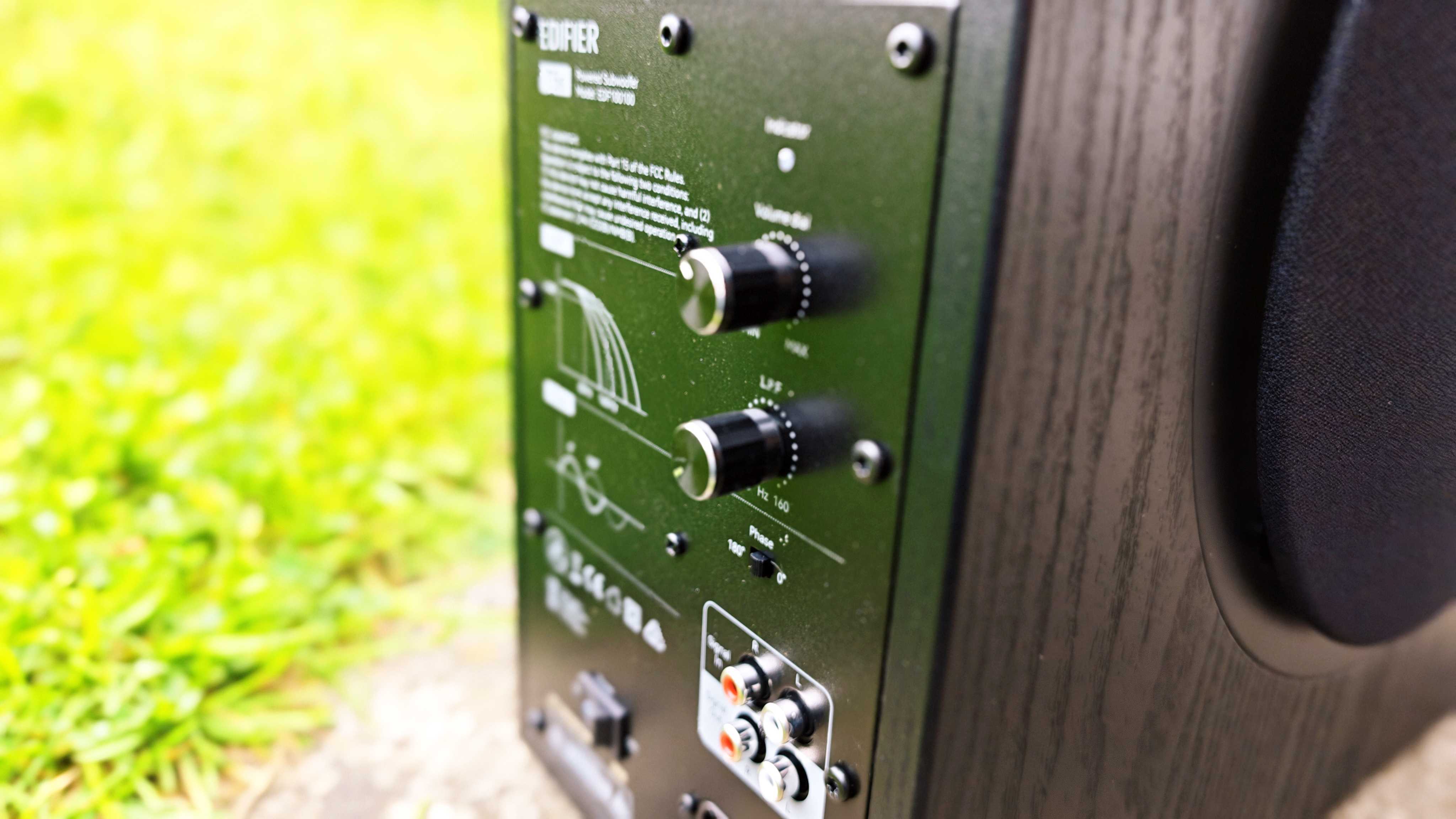 Edifier T5s subwoofer on a green garden lawn