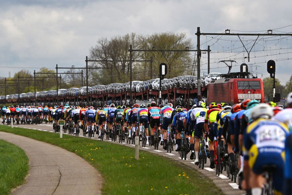 SCHOTEN BELGIUM APRIL 03 EDITORS NOTE Alternate crop A general view of the peloton passing close to a railway convoy during the 112th Scheldeprijs 2024 Mens Elite a 2053km one day race from Terneuzen to Schoten on April 03 2024 in Schoten Belgium Photo by Luc ClaessenGetty Images