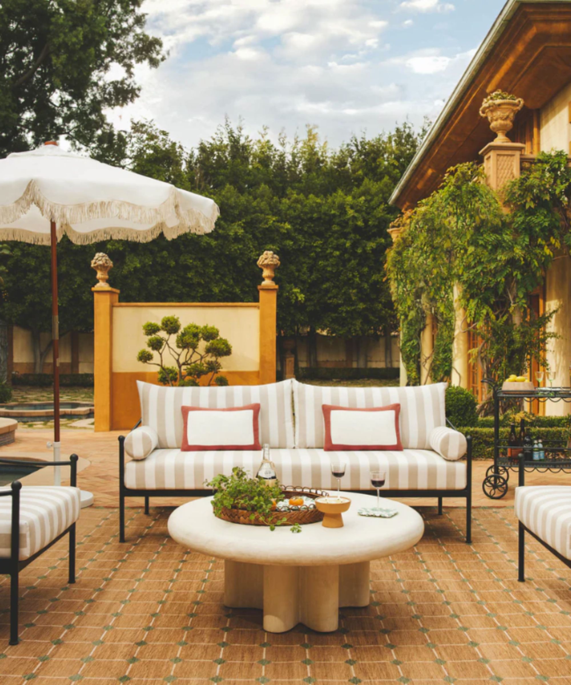 Outdoor living area with sofa, coffee table and parasol