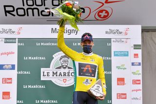 MARTIGNY SWITZERLAND APRIL 28 Rohan Dennis of Australia and Team INEOS Grenadiers Yellow Leader Jersey at podium during the 74th Tour De Romandie 2021 Stage 1 a 1681km stage from Aigle to Martigny Mask Covid safety measures Flowers Trophy TDR2021 TDRnonstop UCIworldtour on April 28 2021 in Martigny Switzerland Photo by Luc ClaessenGetty Images