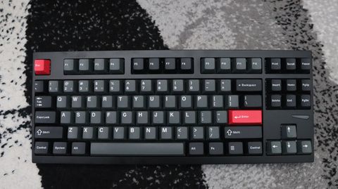 Lemokey L4 gaming keyboard on a carpet with lighting enabled.