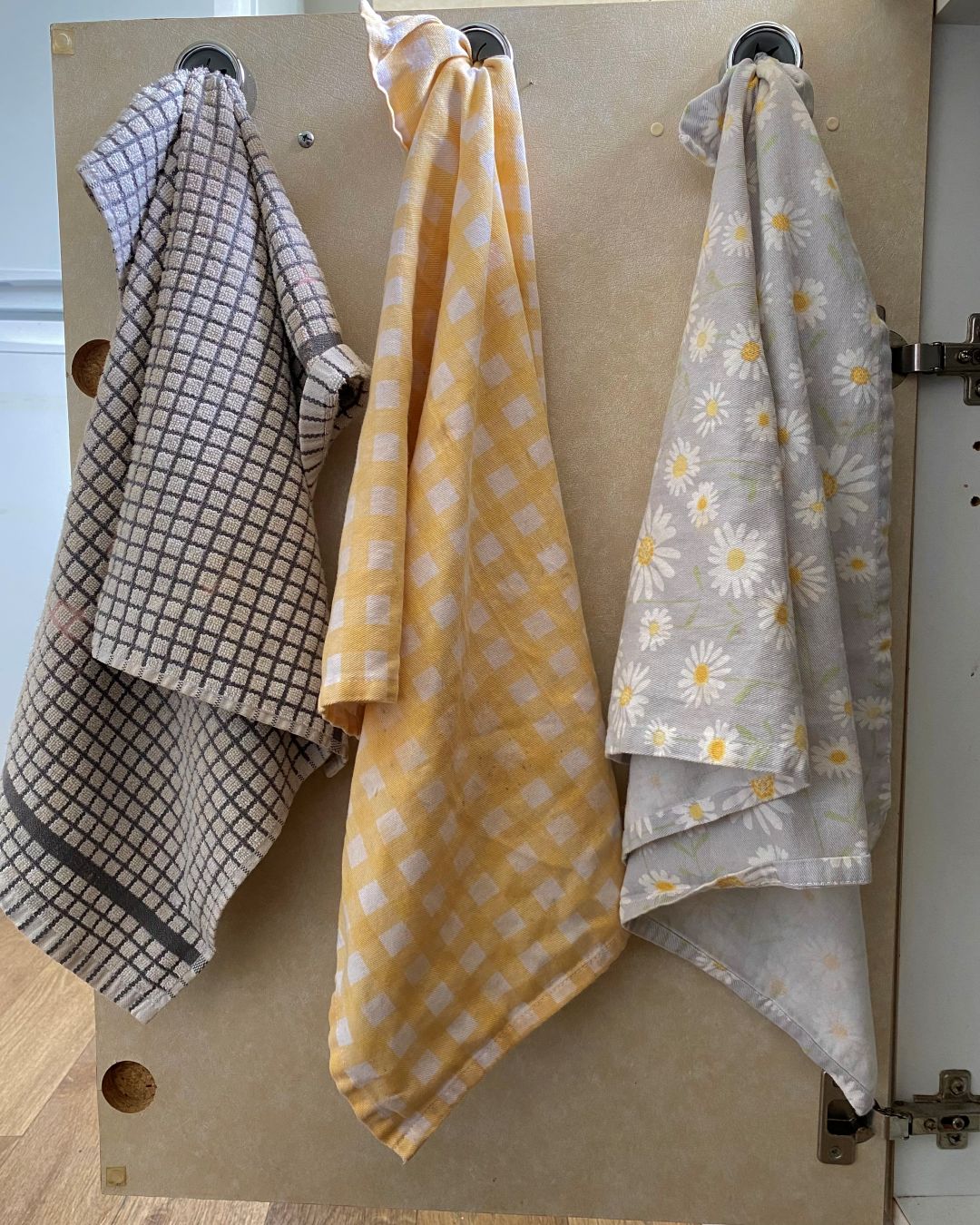 tea towels hanging on cupboard door