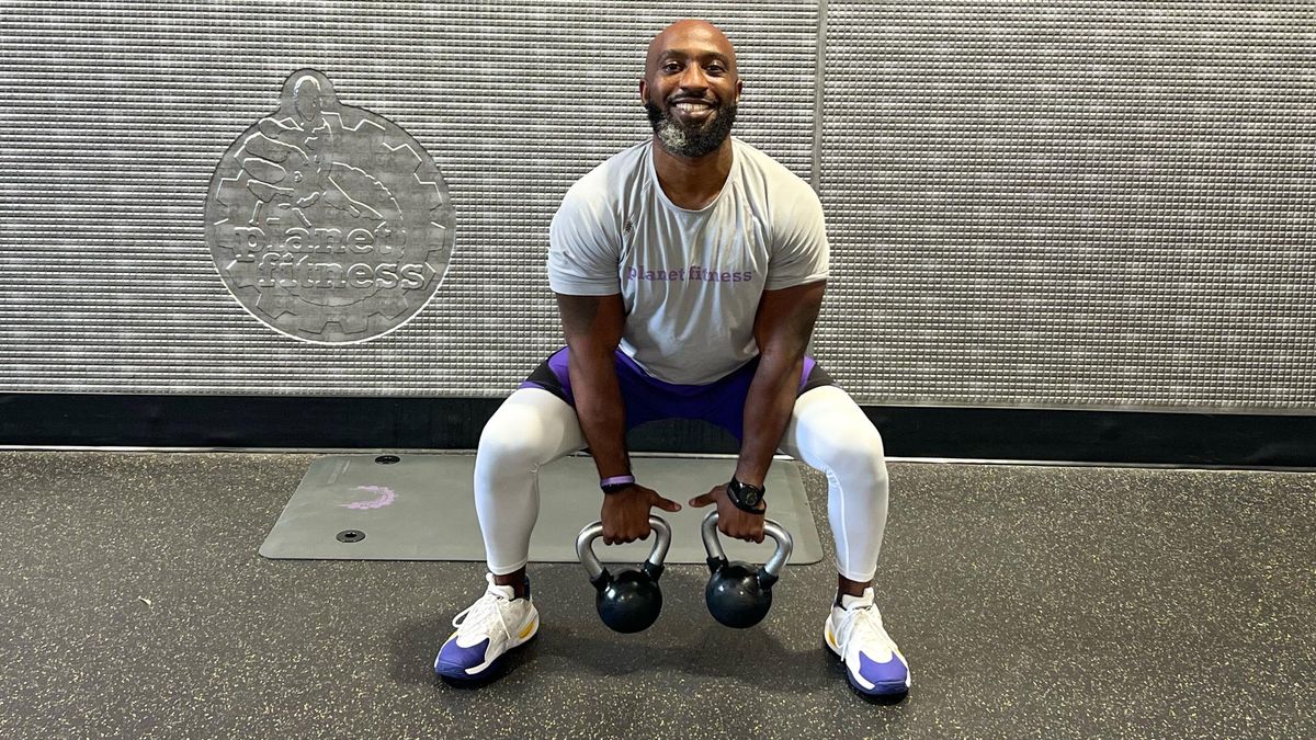Teddy Savage performing a kettlebell clean to overhead press