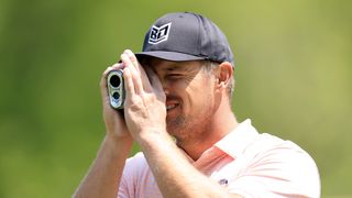 Bryson DeChambeau using a rangefinder at the 2023 PGA Championship