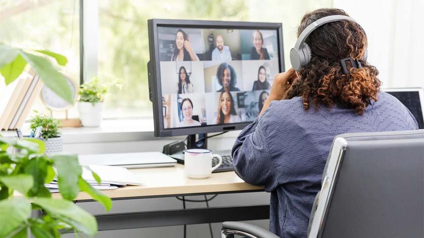 Telecommuting from her home office, the unrecognizable woman joins a virtual work meeting.