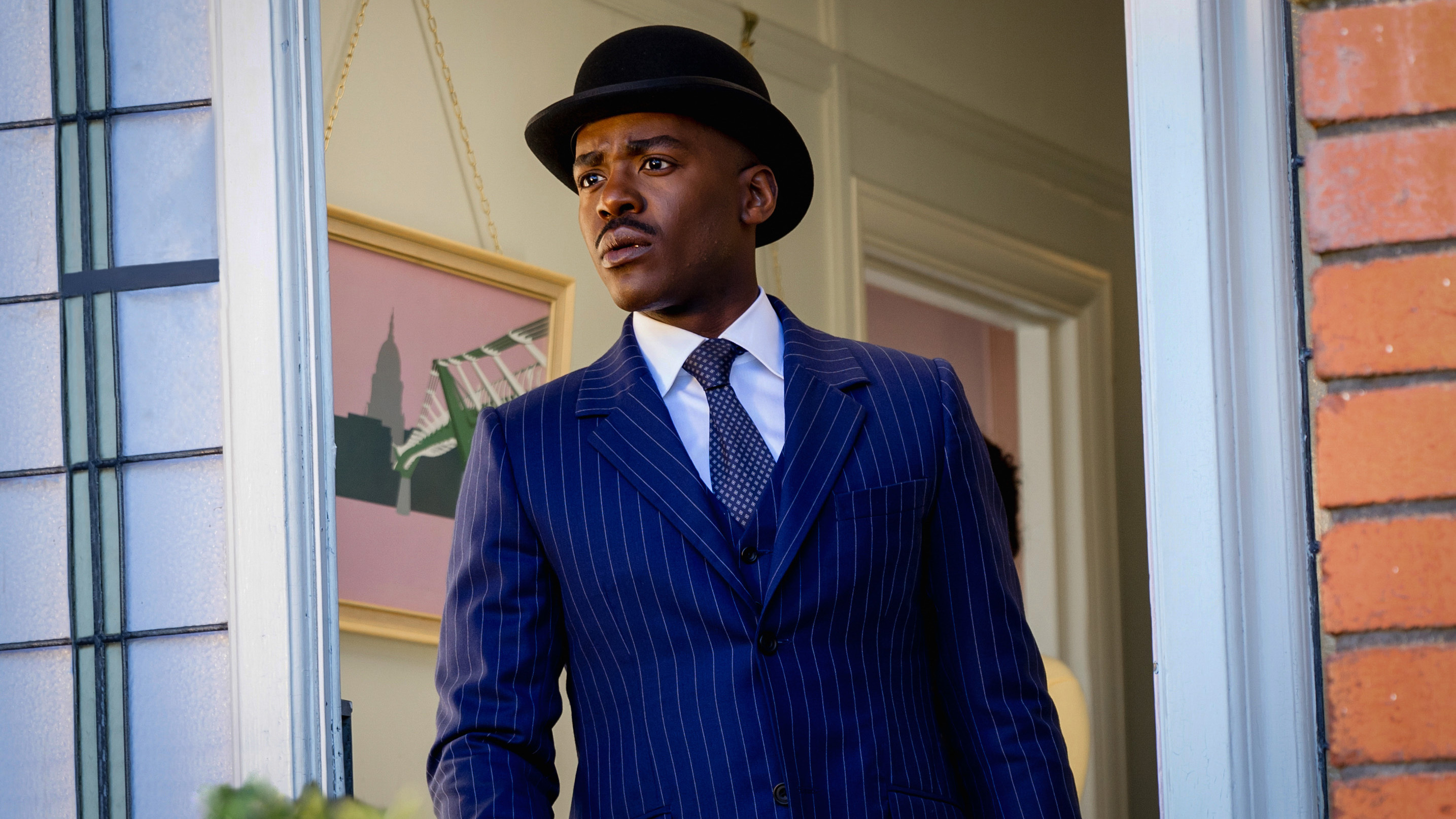 Ncuti Gatwa as the Doctor in a suit, tie, and bowler hat in Doctor Who's 'Wish World.'
