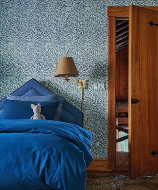 child's bedroom with blue bedding and triangular headboard