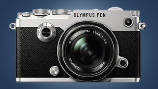 The Olympus Pen F camera on a blue background