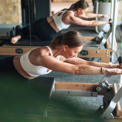 A woman doing a ten minute Pilates workout in studio